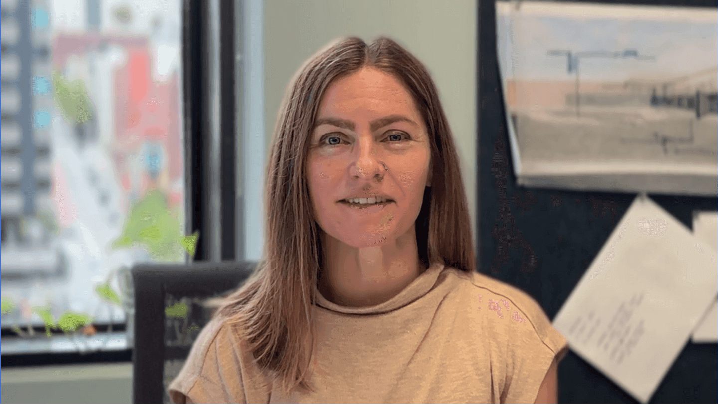 Thumbnail of a customer testimonial video showing a smiling woman in an office